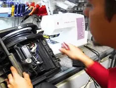 Vacuum repair technician servicing internal components on a workbench in Riverside, CA