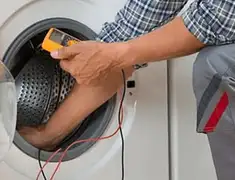 Washing machine repair technician testing a front-load washer with diagnostic tools in Riverside, CA